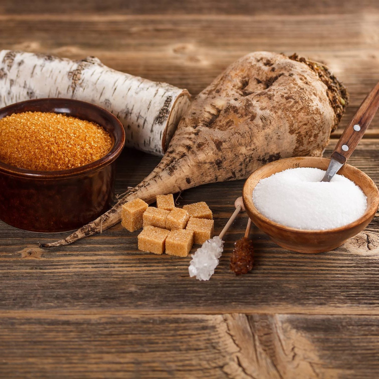 White and brown sugar White and brown sugar in bowl on a  wooden surface